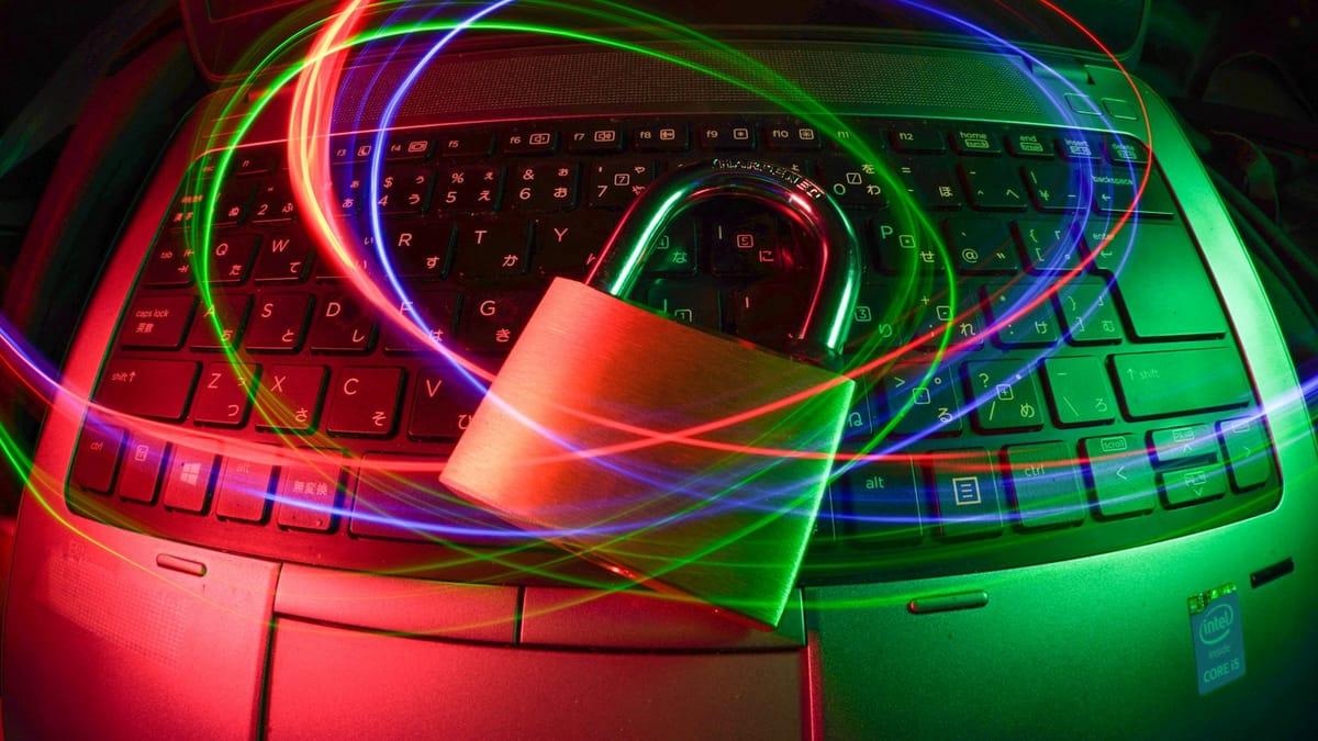Padlock resting on a laptop keyboard with light trails