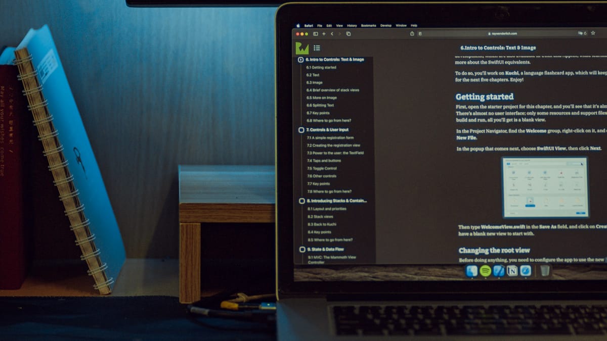 Developer workstation with code on a monitor and laptop