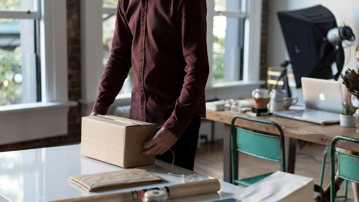 Small business owner packing an order at a table