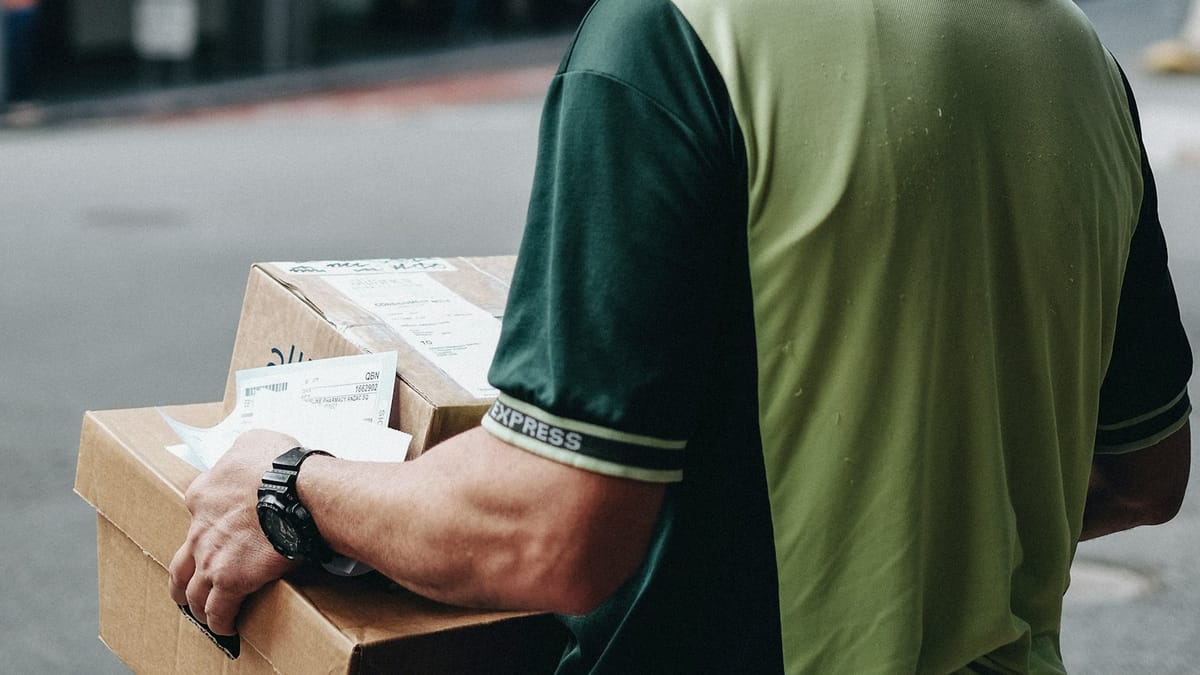 Man carrying cardboard boxes for shipping