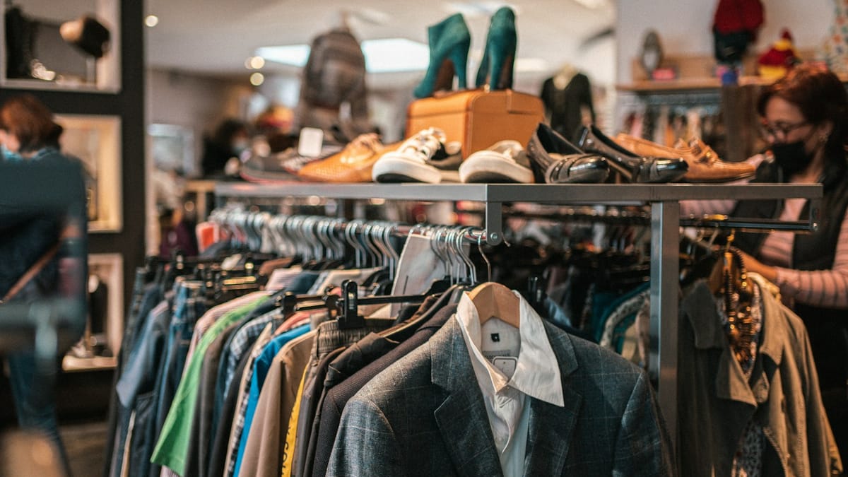 Rack of secondhand clothes and shoes in a boutique
