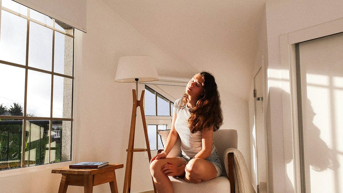 Woman sitting in a chair in warm morning sunlight