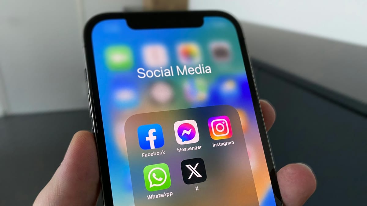 Person holding a phone showing a social media feed